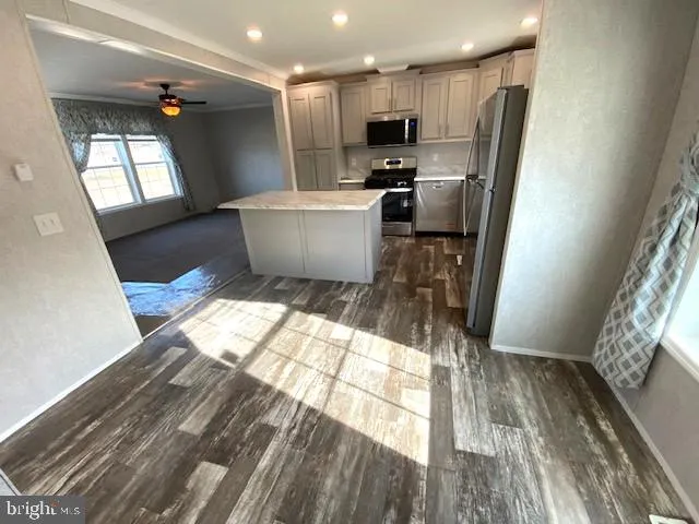 a view of kitchen with refrigerator microwave and wooden floor