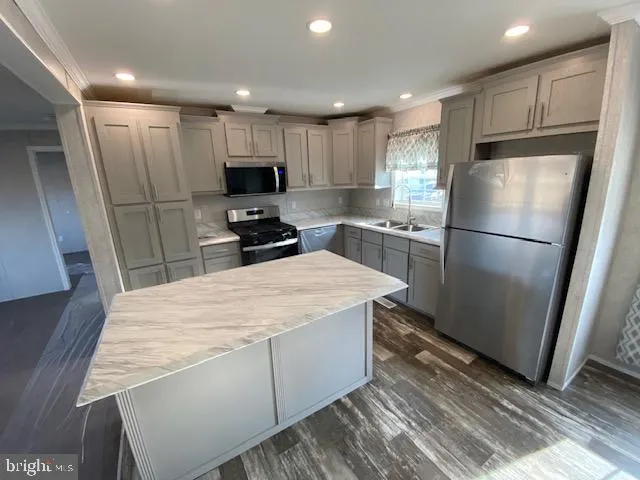 a kitchen with a refrigerator a sink and cabinets