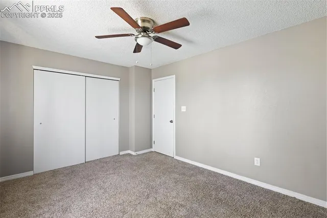 an empty room with a ceiling fan and a ceiling fan