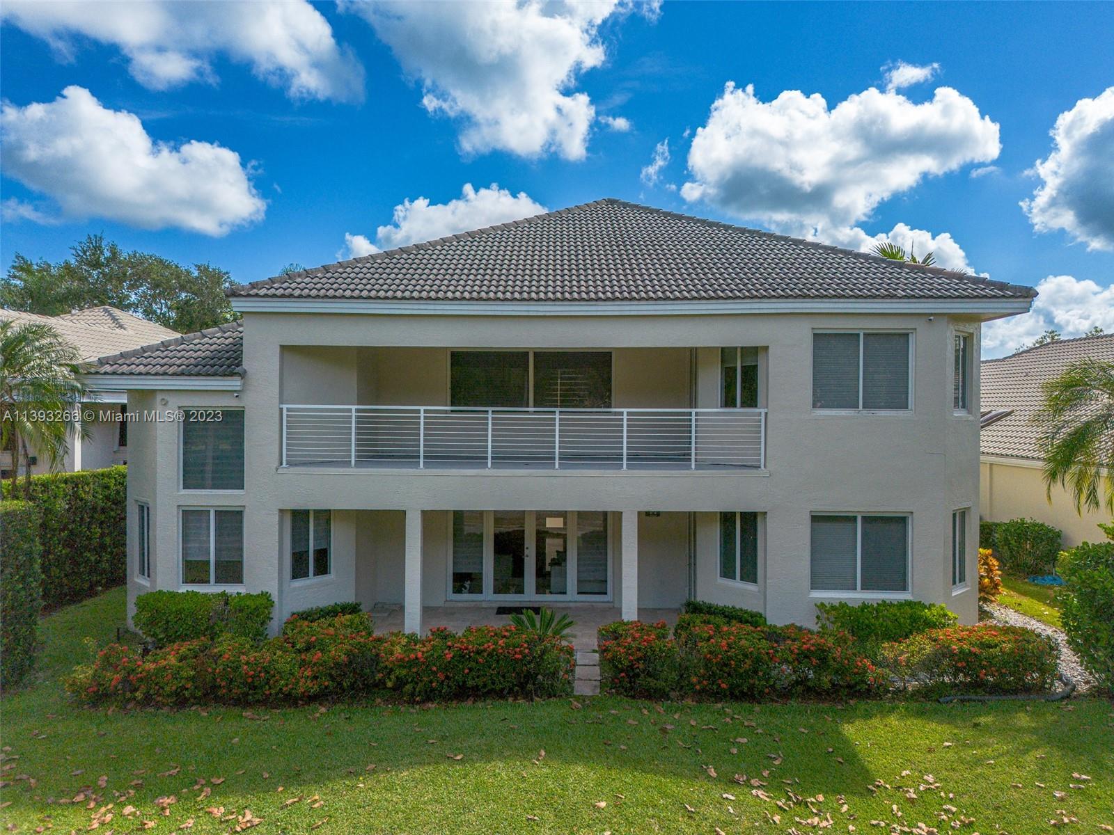 2707 Pinehurst Drive Weston, FL 33332 - Photo 14 of 59 a front view of a house with garden