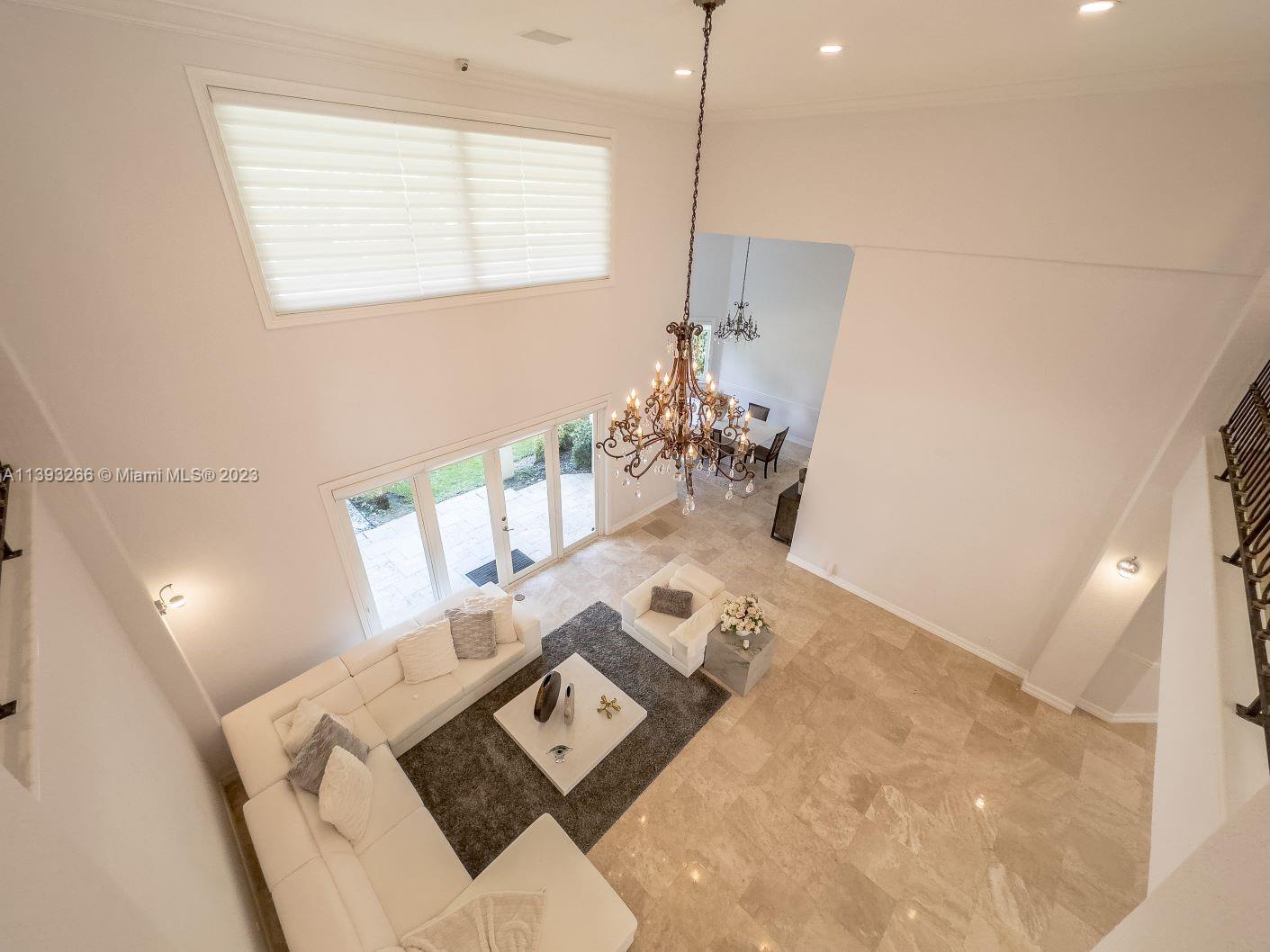 2707 Pinehurst Drive Weston, FL 33332 - Photo 17 of 59 a living room with furniture and a chandelier