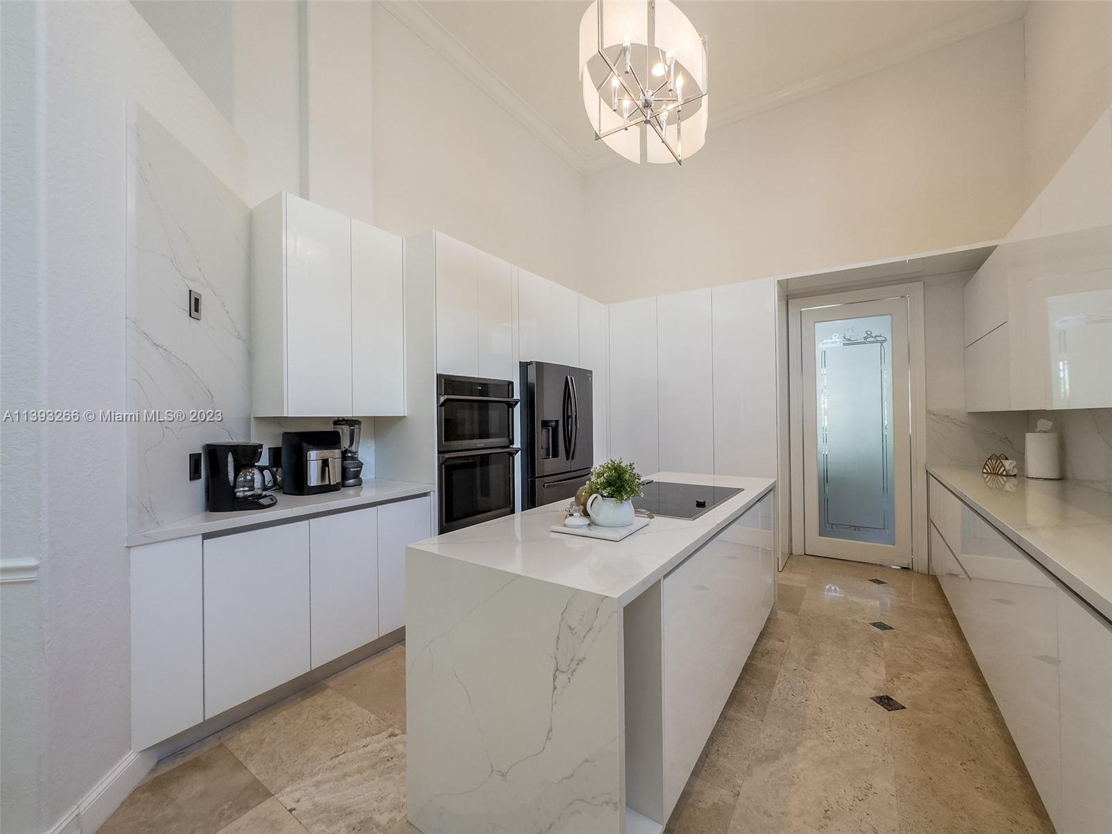 2707 Pinehurst Drive Weston, FL 33332 - Photo 20 of 59 a large white kitchen with a stove and refrigerator