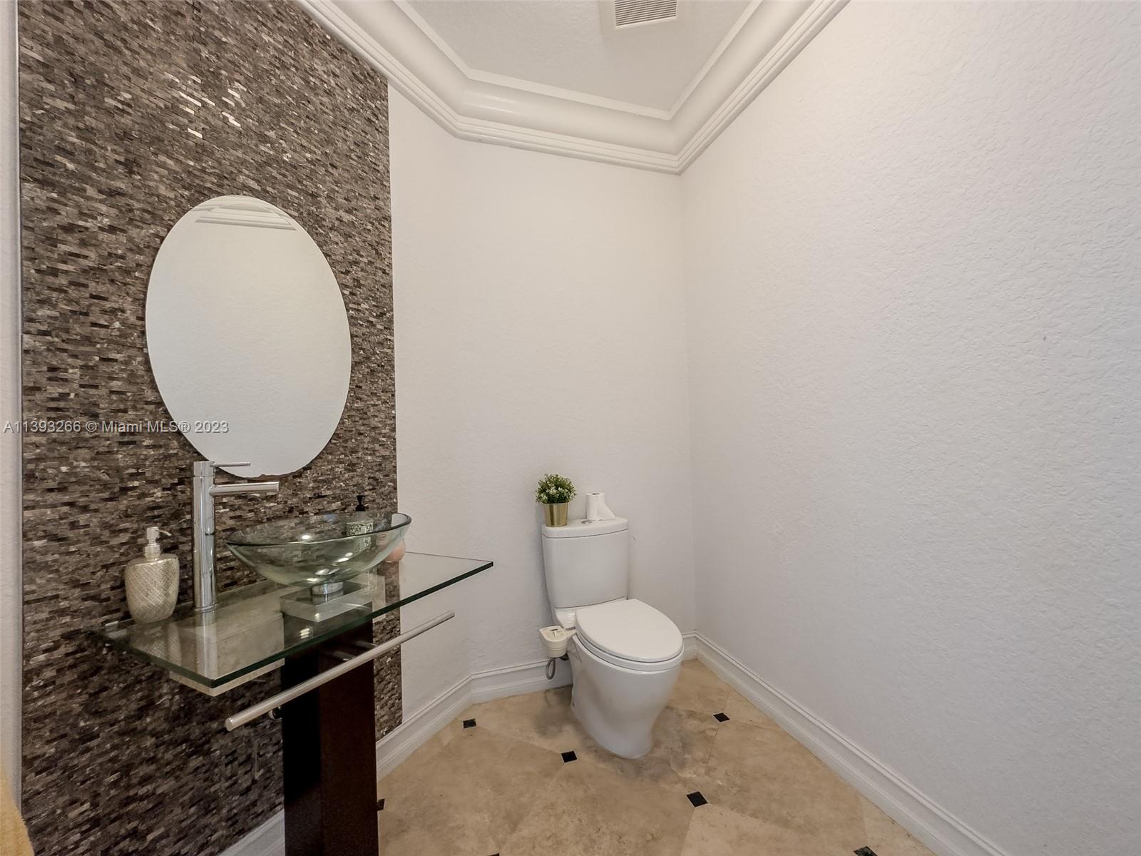 2707 Pinehurst Drive Weston, FL 33332 - Photo 27 of 59 a bathroom with a toilet and a mirror