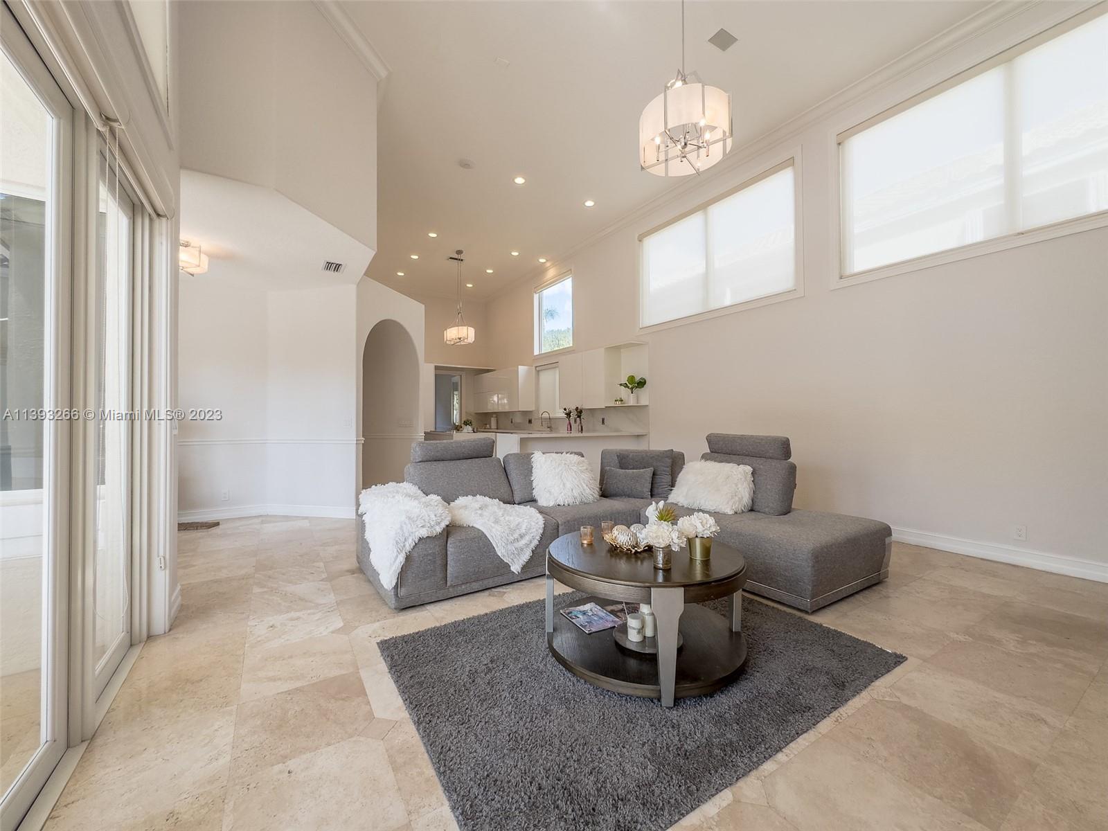 2707 Pinehurst Drive Weston, FL 33332 - Photo 30 of 59 a living room with furniture and a chandelier