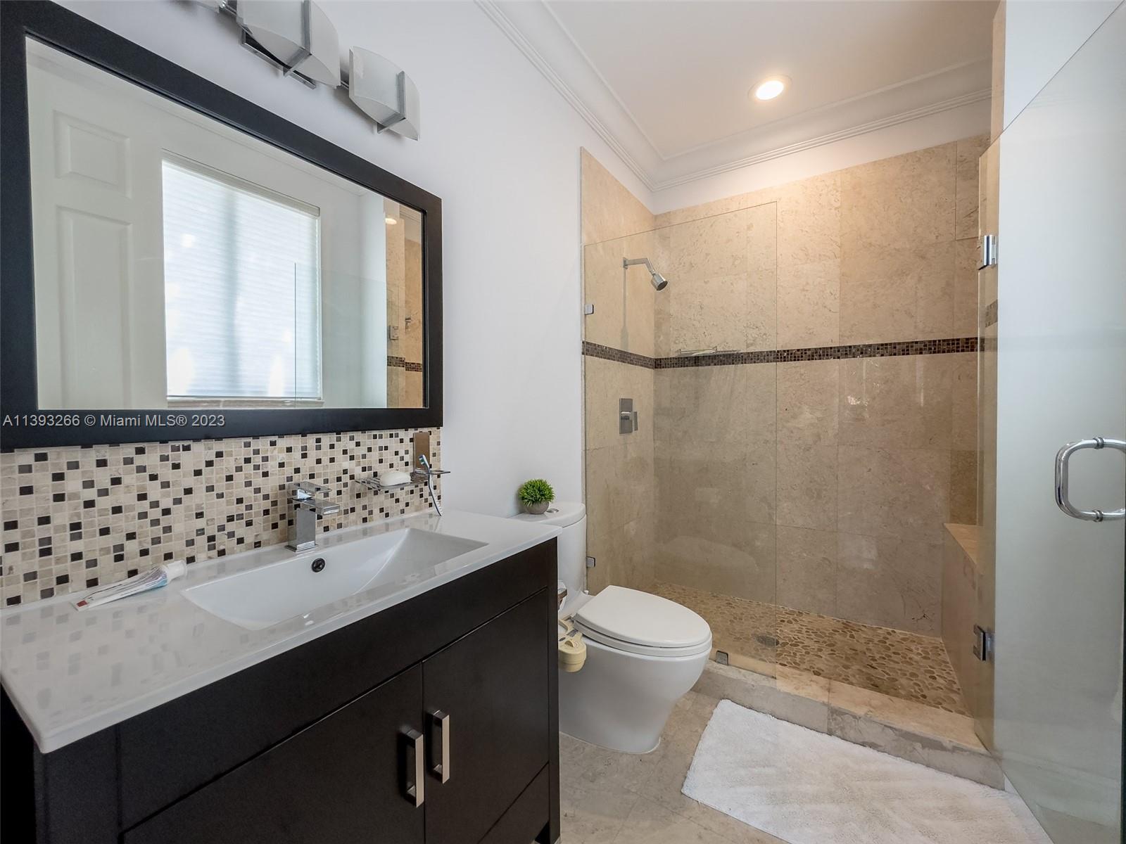 2707 Pinehurst Drive Weston, FL 33332 - Photo 37 of 59 a bathroom with a sink a toilet a mirror and shower