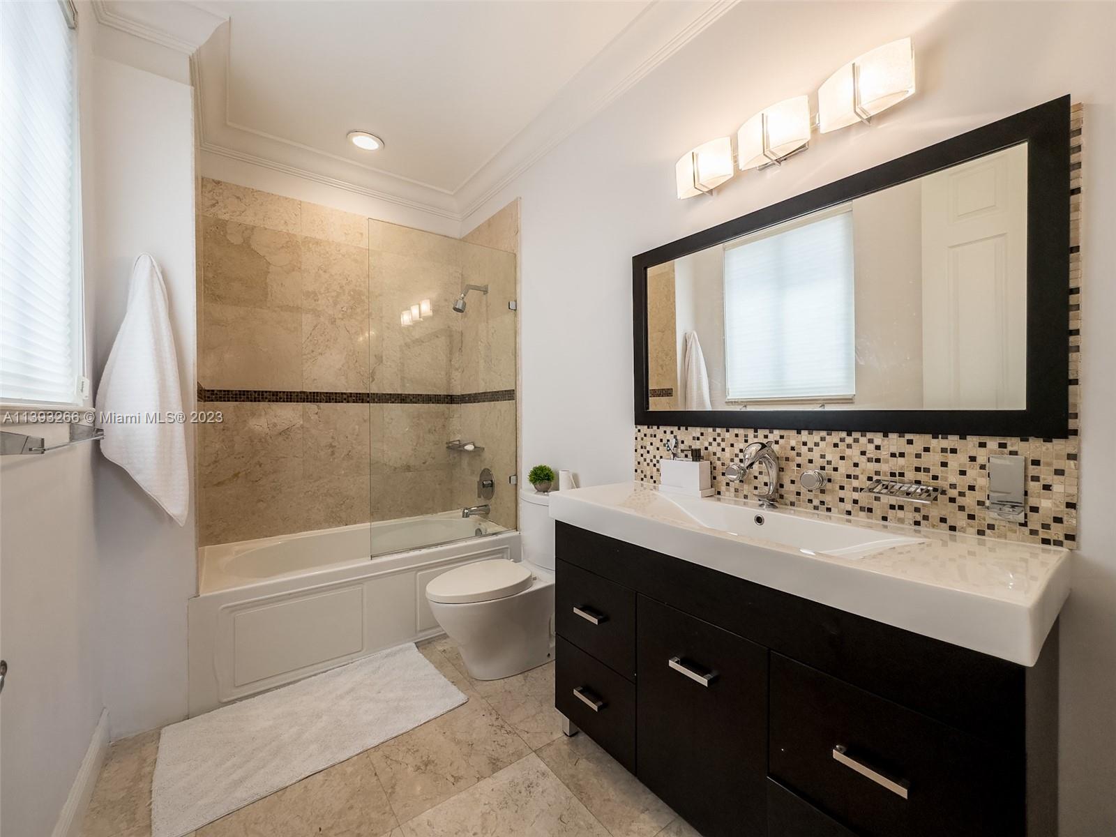 2707 Pinehurst Drive Weston, FL 33332 - Photo 39 of 59 a bathroom with a sink toilet a mirror and shower