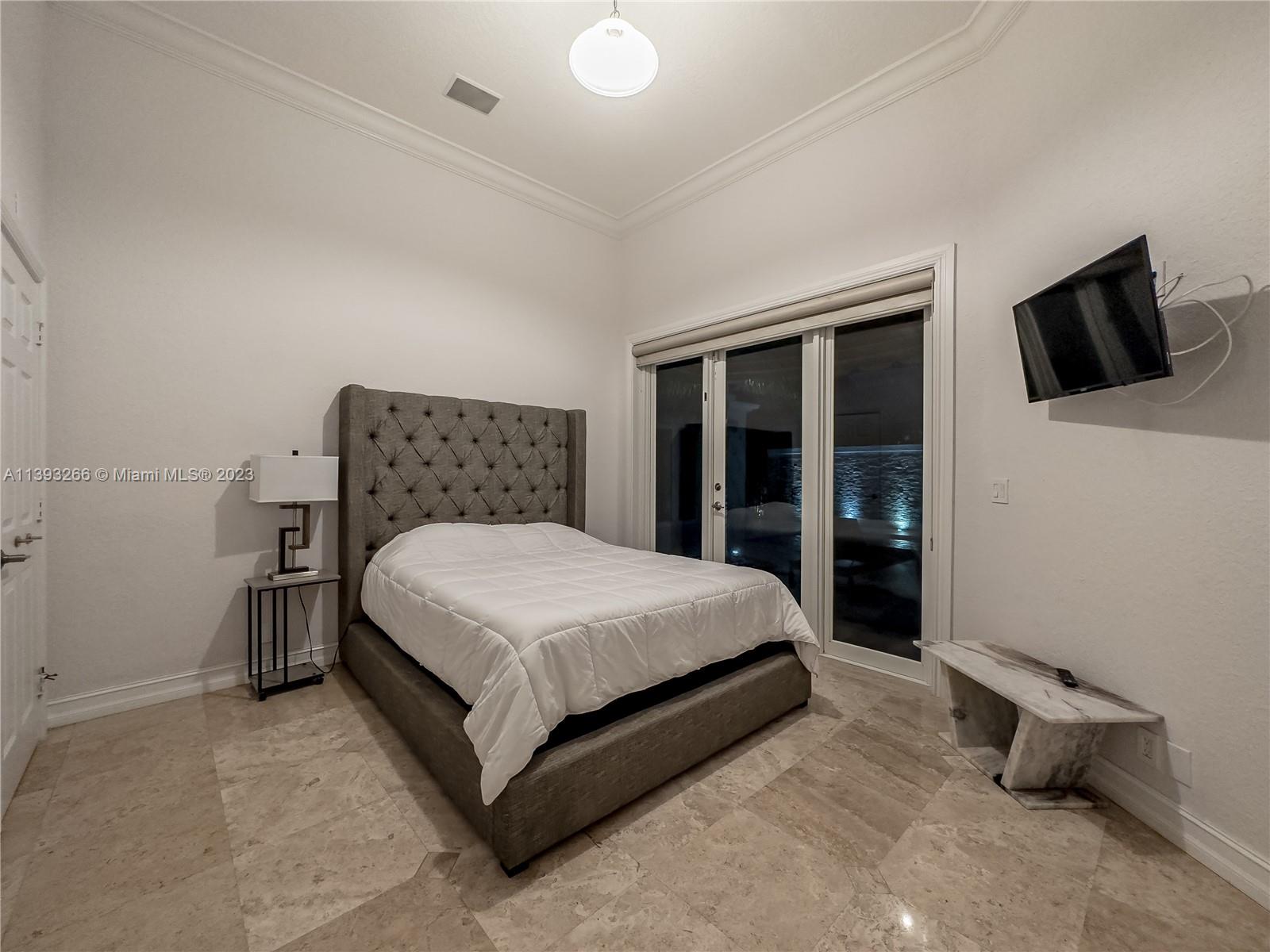 2707 Pinehurst Drive Weston, FL 33332 - Photo 42 of 59 a bed sitting in a bedroom and tv