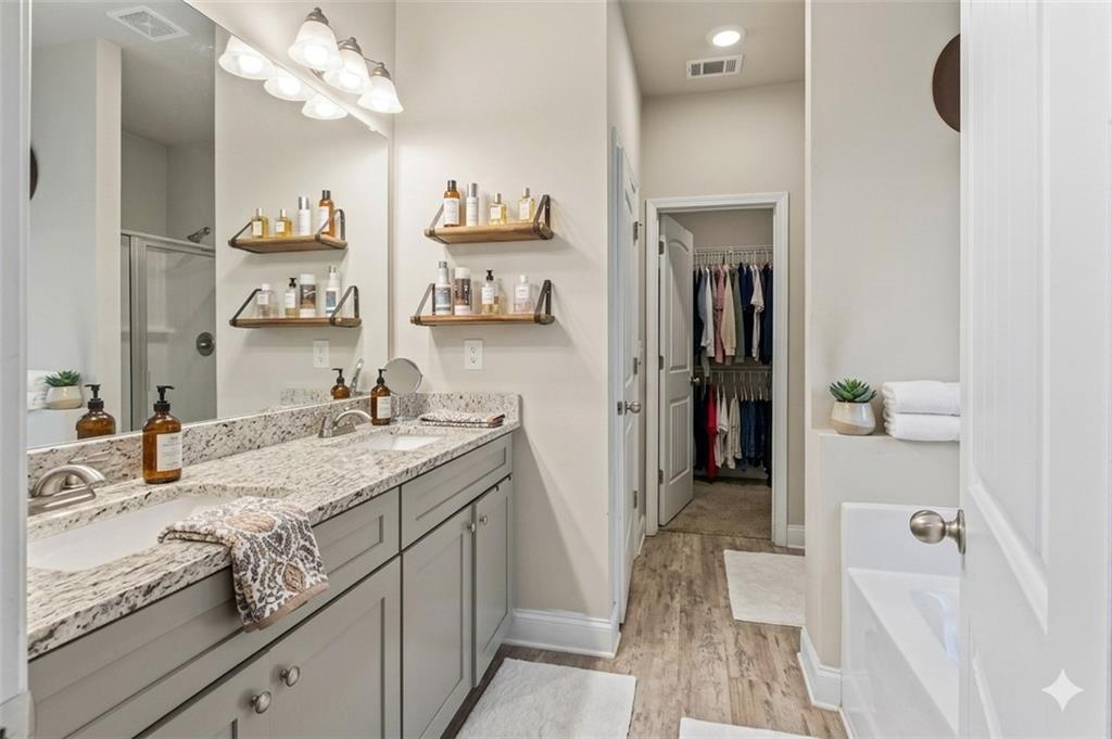 171 Strickland Loop Forsyth, GA 31029 - Photo 13 of 25 a bathroom with a granite countertop sink a mirror and a shower