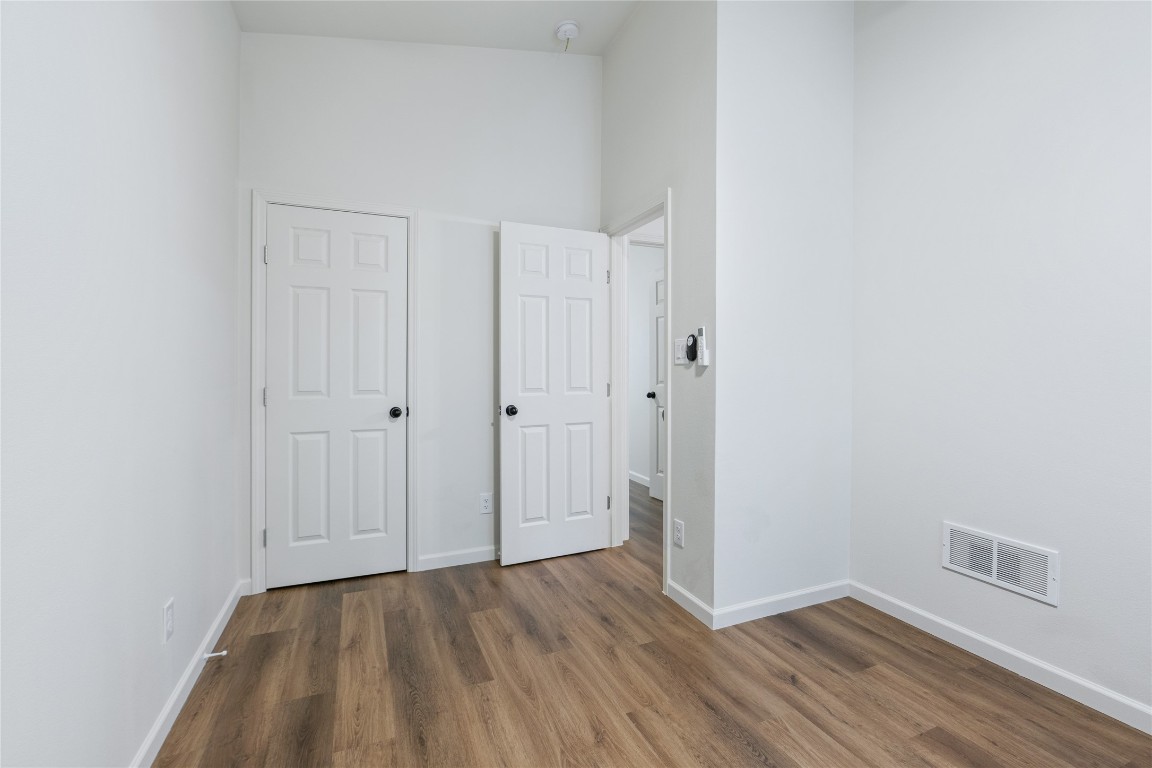 23081 Nameless Road, Unit D Leander, TX 78641 - Photo 14 of 16 a view of an empty room with closet and wooden floor