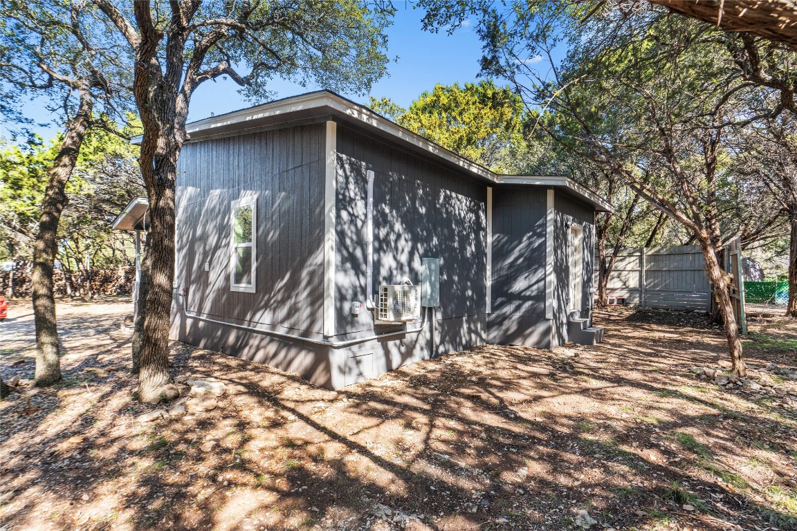 23081 Nameless Road, Unit D Leander, TX 78641 - Photo 16 of 16 a wooden house with trees in front of it