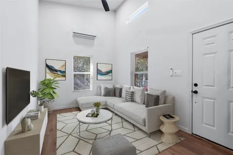 a living room with furniture and wooden floor
