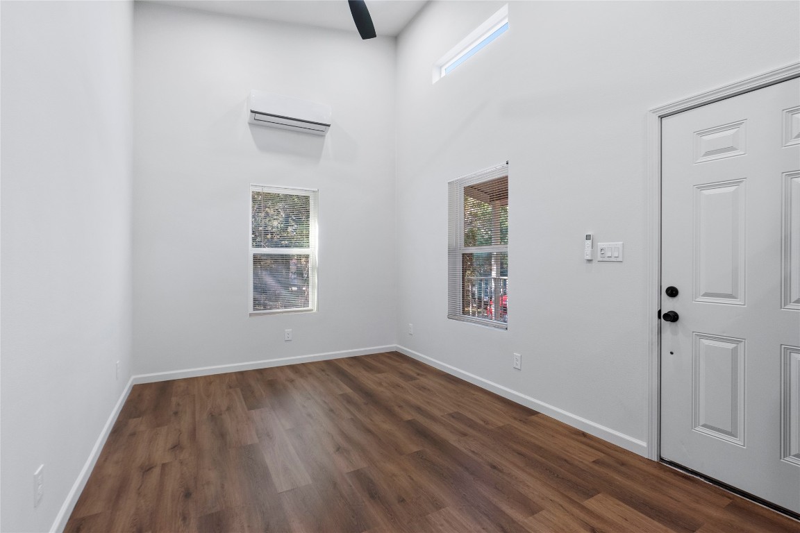 23081 Nameless Road, Unit D Leander, TX 78641 - Photo 4 of 16 an empty room with wooden floor and windows