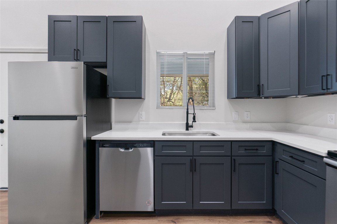 23081 Nameless Road, Unit D Leander, TX 78641 - Photo 6 of 16 a kitchen with a sink and a refrigerator