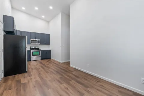 a kitchen with stainless steel appliances a refrigerator and a stove top oven