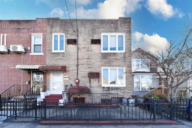 a view of a brick house with many windows