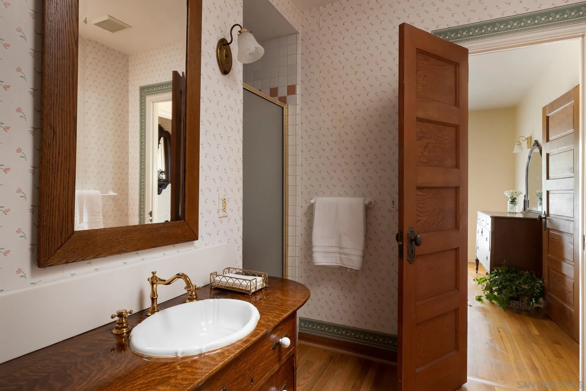 9844 Summit Drive La Mesa, CA 91941 - Photo 30 of 58 a bathroom with a sink a mirror and a shower