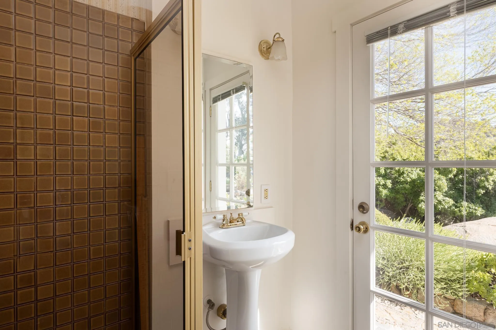 9844 Summit Drive La Mesa, CA 91941 - Photo 36 of 58 a bathroom with a sink a mirror and a shower