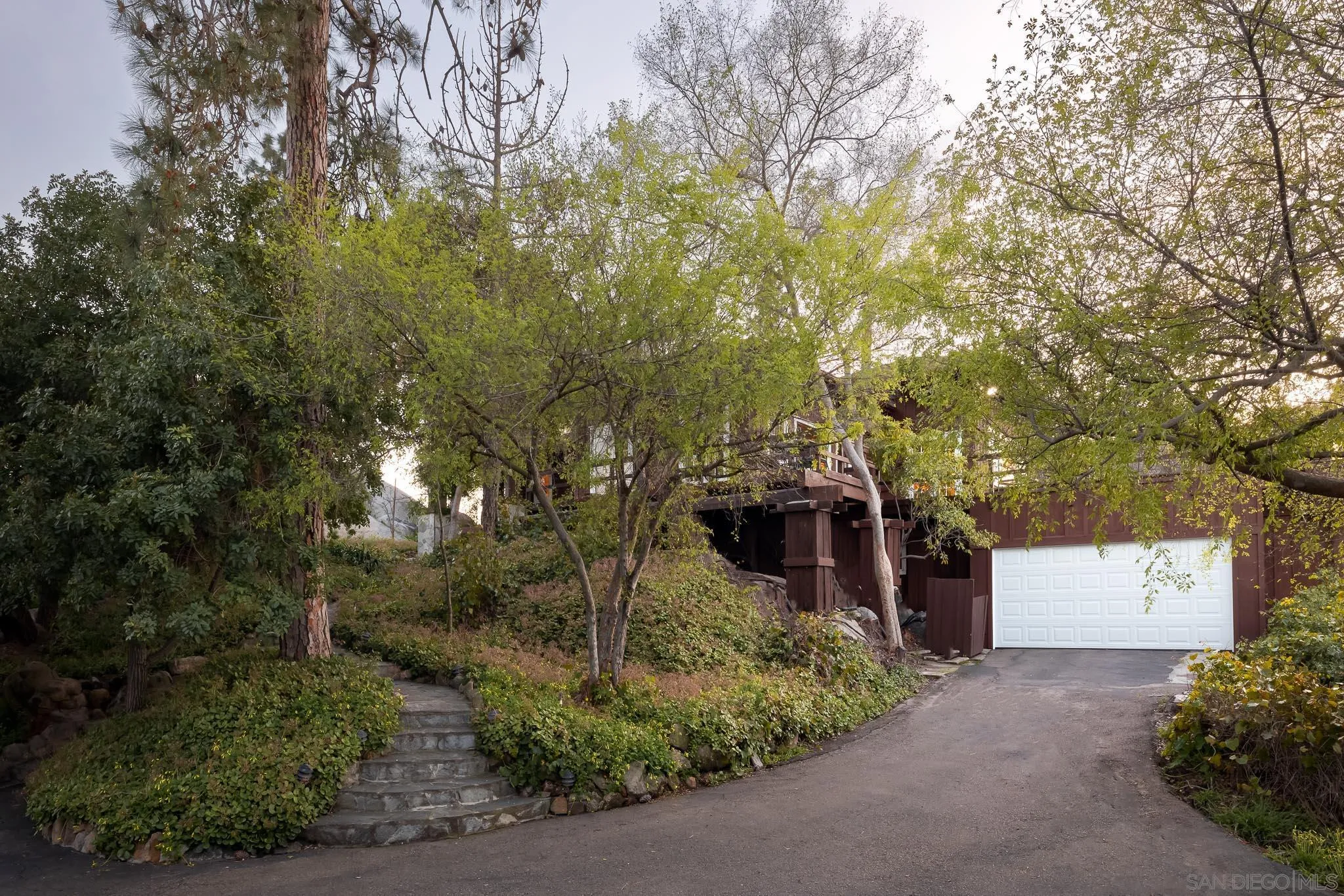 9844 Summit Drive La Mesa, CA 91941 - Photo 10 of 58 a front view of a house with a yard and tree s