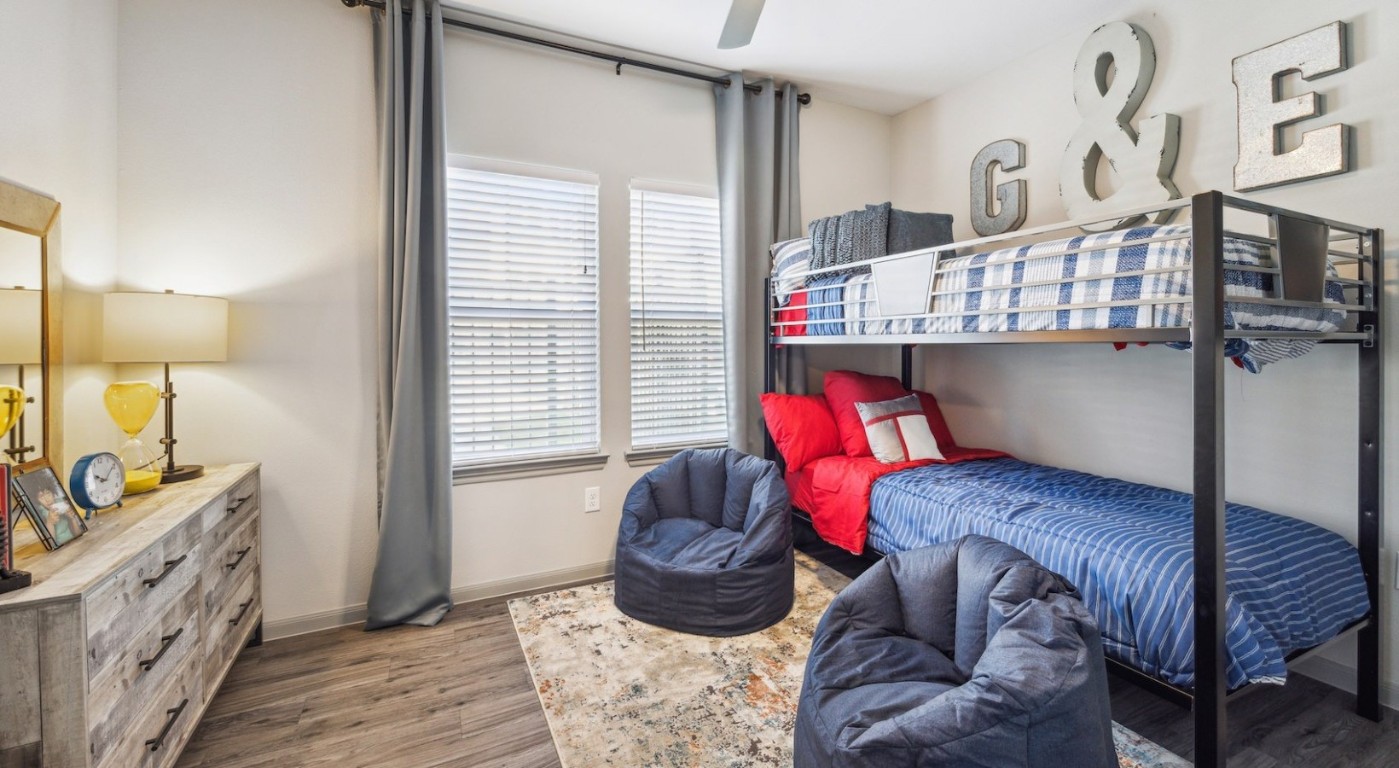 12752 North Houston Rosslyn Road, Unit 1231 Houston, TX 77086 - Photo 6 of 14 a bedroom with a bed and wooden floor