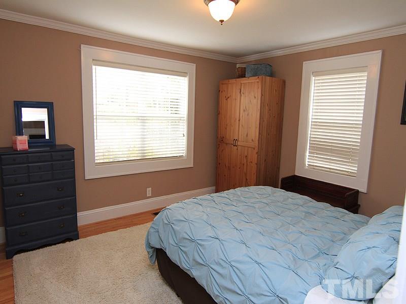 1630 Bickett Boulevard Raleigh, NC 27608 - Photo 14 of 18 a bedroom with a bed and a window