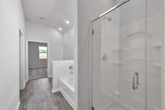 a bathroom with a bathtub and a shower