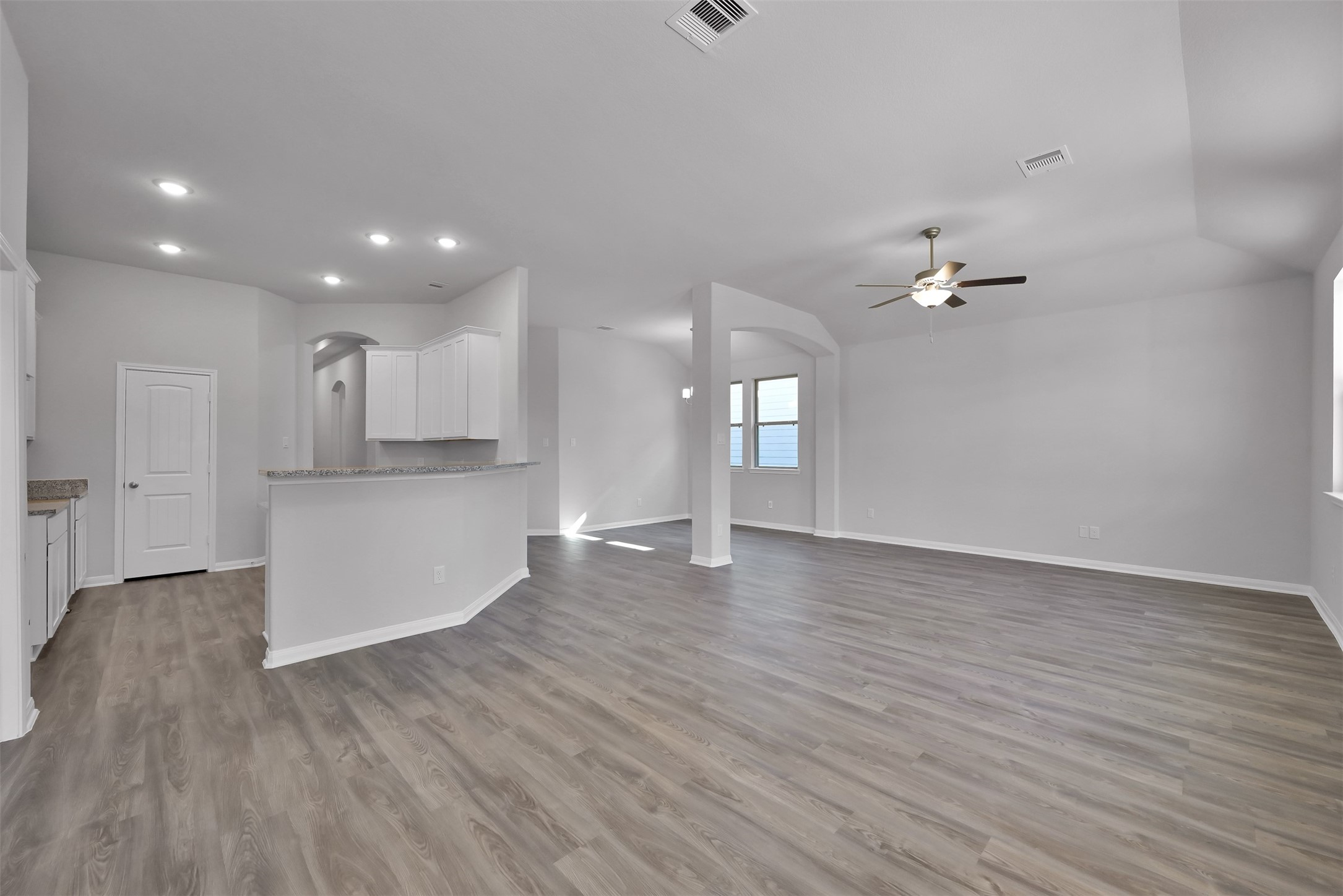 17620 Cedar Crest Drive Conroe, TX 77306 - Photo 5 of 15 a view of an empty room and kitchen with wooden floor