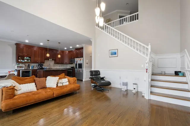 a view of a living room and kitchen floor to ceiling window