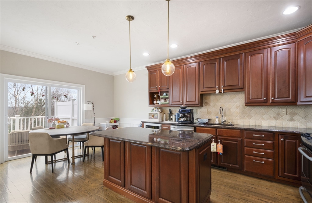 806 Ledgewood Way, Unit 806 Clinton, MA 01510 - Photo 16 of 42 a kitchen with a sink a stove a dining table and chairs