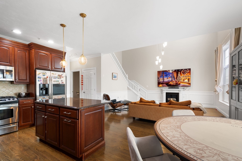 806 Ledgewood Way, Unit 806 Clinton, MA 01510 - Photo 18 of 42 a living room with furniture kitchen view and a wooden floor