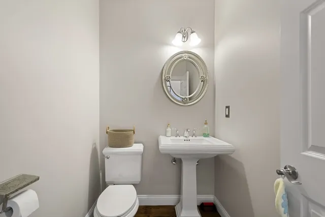 a bathroom with a sink mirror toilet and vanity