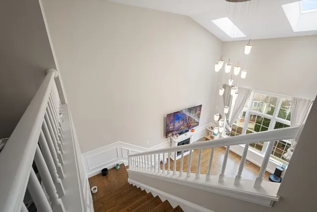 a view of staircase with a large window and wooden floor