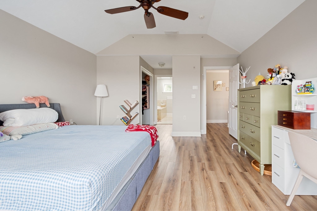 806 Ledgewood Way, Unit 806 Clinton, MA 01510 - Photo 26 of 42 a bedroom with a bed and a chandelier