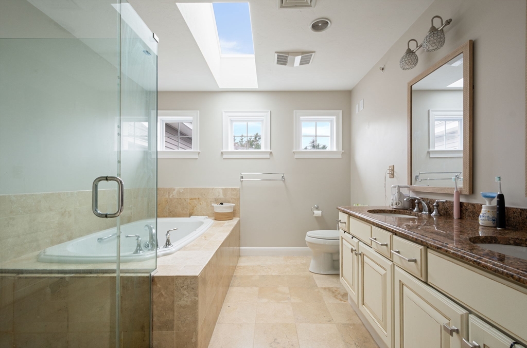 806 Ledgewood Way, Unit 806 Clinton, MA 01510 - Photo 27 of 42 a bathroom with a granite countertop sink a toilet and mirror