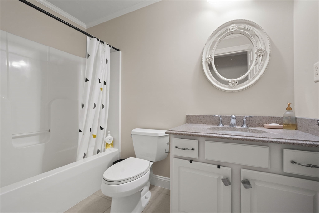 806 Ledgewood Way, Unit 806 Clinton, MA 01510 - Photo 30 of 42 a bathroom with a granite countertop toilet a sink and a mirror