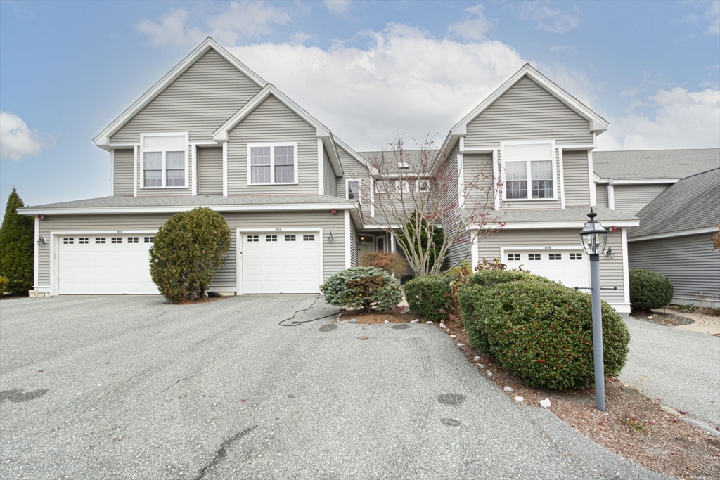 806 Ledgewood Way, Unit 806 Clinton, MA 01510 - Photo 3 of 42 a view of a house with potted plants and a large parking space