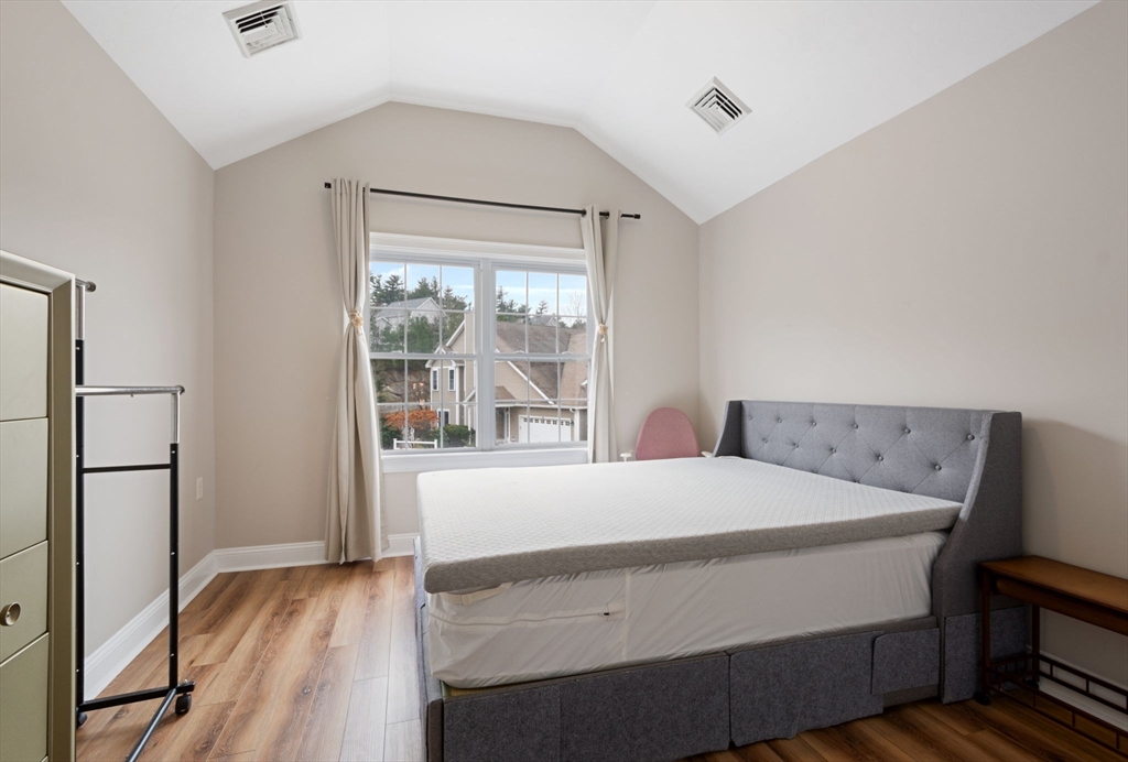 806 Ledgewood Way, Unit 806 Clinton, MA 01510 - Photo 31 of 42 a bedroom with a bed and a large window