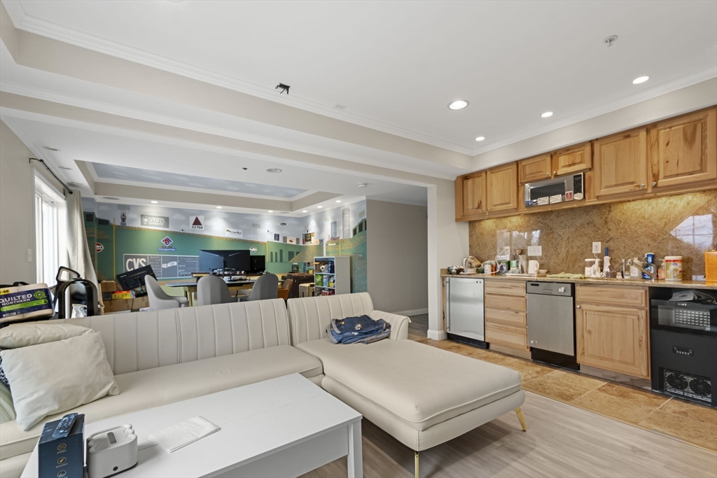 806 Ledgewood Way, Unit 806 Clinton, MA 01510 - Photo 34 of 42 a large living room with stainless steel appliances kitchen island granite countertop a large kitchen island a stove and a refrigerator