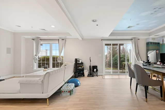 a living room with furniture and large windows