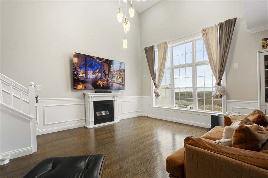 806 Ledgewood Way, Unit 806 Clinton, MA 01510 - Photo 9 of 42 a living room with furniture a fireplace and a flat screen tv