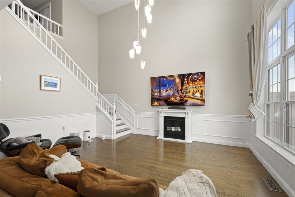 806 Ledgewood Way, Unit 806 Clinton, MA 01510 - Photo 10 of 42 a living room with furniture and a flat screen tv