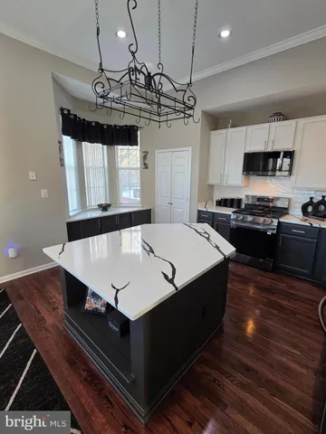 a kitchen with a stove a sink and a refrigerator