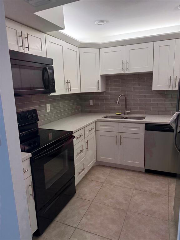 a kitchen with cabinets stainless steel appliances and sink