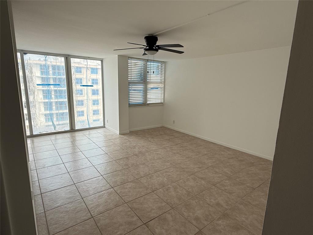 111 Briny Avenue, Unit PH17 Pompano Beach, FL 33062 - Photo 2 of 11 an empty room with windows and entrance