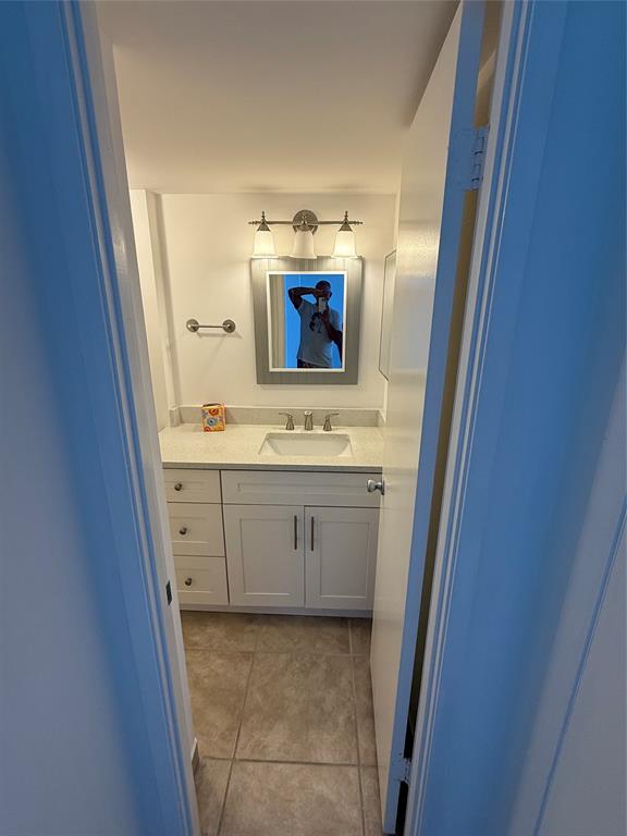 111 Briny Avenue, Unit PH17 Pompano Beach, FL 33062 - Photo 3 of 11 a bathroom with a sink and a mirror