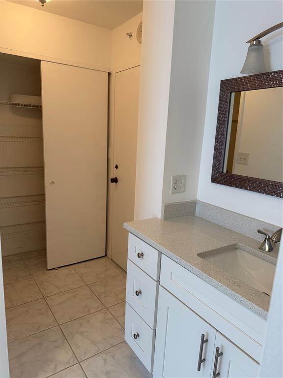 111 Briny Avenue, Unit PH17 Pompano Beach, FL 33062 - Photo 7 of 11 a bathroom with a sink and a mirror