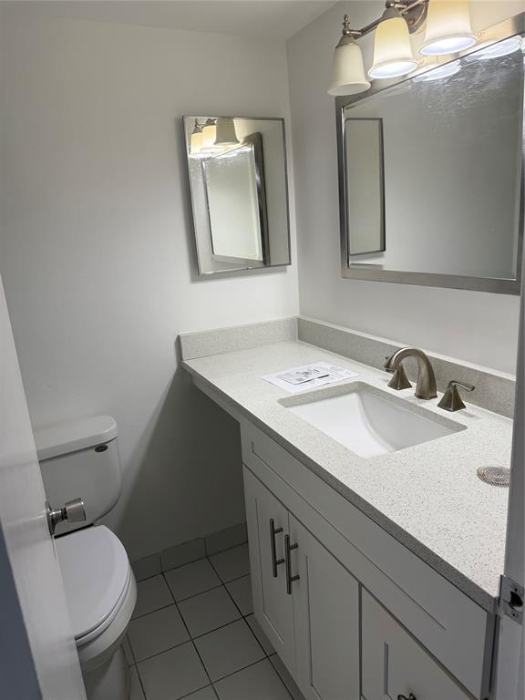 111 Briny Avenue, Unit PH17 Pompano Beach, FL 33062 - Photo 8 of 11 a bathroom with a toilet sink and mirror