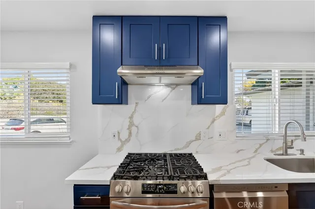 a kitchen with a stove and a sink