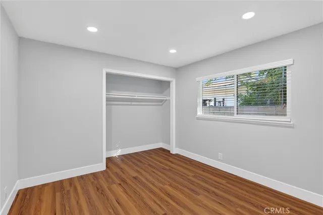 a view of room with window and wooden floor