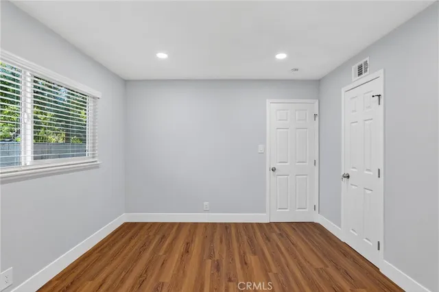 a view of room with window and wooden floor