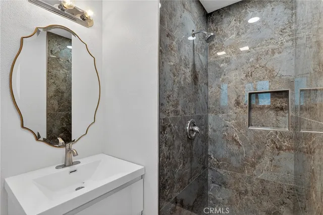 a bathroom with a sink a toilet and shower